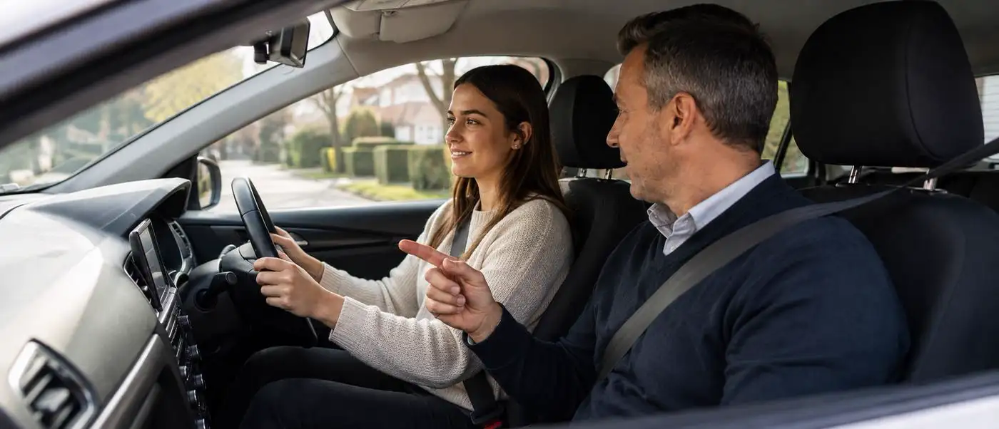 Learner driver at the wheel with a DVSA-approved driving instructor guiding her