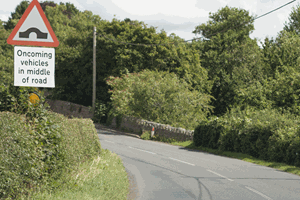 Illustration for the theory test question: What should you do when approaching this bridge?