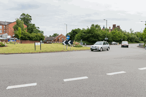 Illustration for the theory test question: What is meant by the broken line at the entrance to the roundabout?