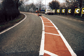 Illustration for the theory test question: What is the reason for the hatched are along the centre of the road?